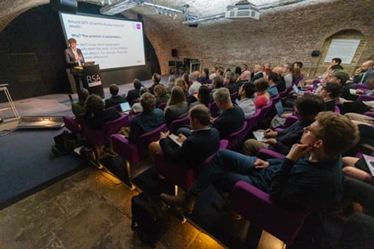 Oliver Case presenting nomad's research to a packed auditorium